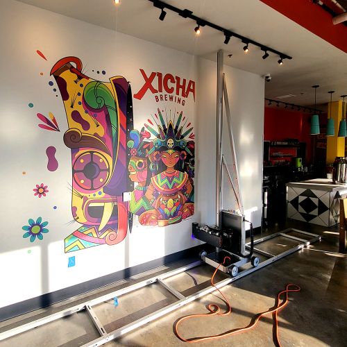 the xicha brewing logo design being printed on a restaurant wall using the Surface Ink Vertical Printer, pionnering wallprinting in the pacific northwest